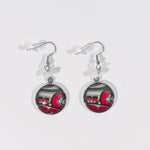 Two circle pendant earring  featuring a red, black and white design. Above the pendants are translucent white semi-precious stones.