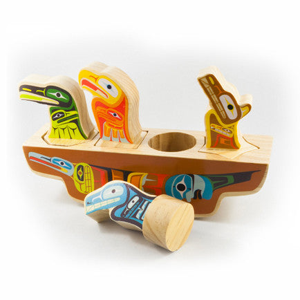 5-piece painted wooden toy with a whale, a wolf, a raven and an eagle sitting in a canoe