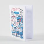 Notebook that features the text “Winnipeg” and illustrations of Winnipeg landmarks