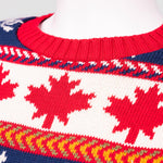 Close-up of sweater neckline and maple leaf pattern mainly in red, white and blue.