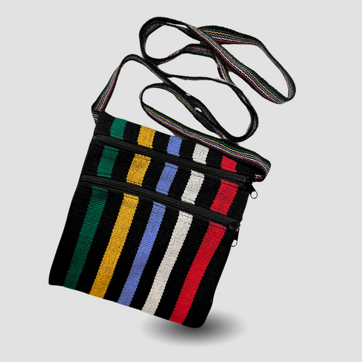 Black crossbody bag with green, yellow, blue, white and red stripes.