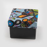 A square box with a colourful printed top.