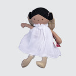 Rag doll with golden wings and booties and a flowy white dress. Her black hair is tied in buns on either side of her head.