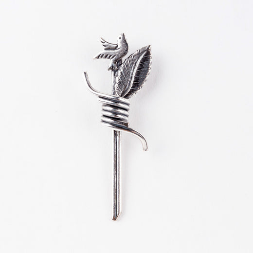 Image of a pin featuring a dove and a leaf