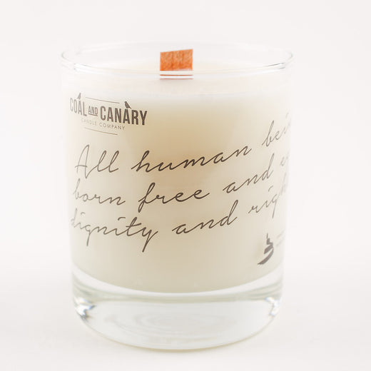 a white candle with the text "All human beings are born free and equal in dignity and rights"
