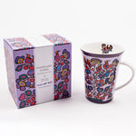 porcelain mug with a floral design; beside it is a gift box with the text “Woodland Floral” and “Bouquet des bois” and a floral illustration that is similar to the mug’s design