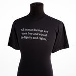 a black t-shirt with the text “All human beings are born free and equal in dignity and rights” 