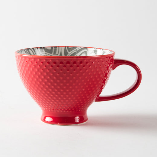 Red mug with a textured exterior