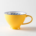 Yellow mug with a textured exterior