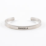 Front of a cuff that features the text “MANDELA”
