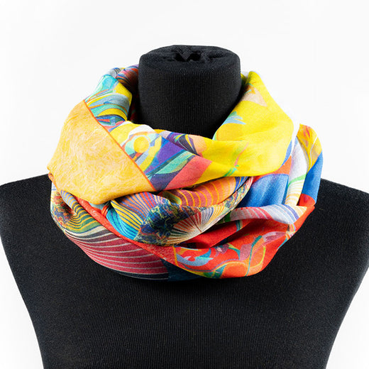 a scarf that features an illustration of a circle, radiant lines and abstract shapes with vibrant colours