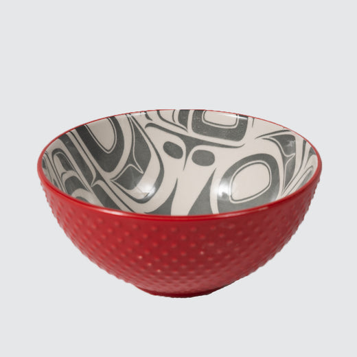 Red textured bowl featuring an inner contemporary Indigenous pattern of eagles.