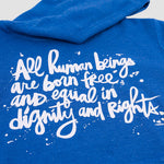 Close-up of white stylized script on blue hoodie.
