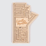 Wooden labyrinth in the shape of Manitoba, seen from the top. The words “Friendly Manitoba” are sculpted in the middle.