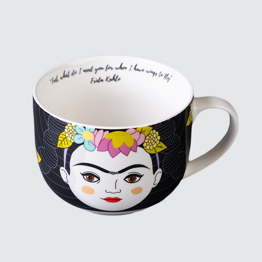 White porcelain mug with a design of a woman’s face wearing a crown of flowers, on a black background. On the inside of the mug, just below the rim, is a message in a script-like font.