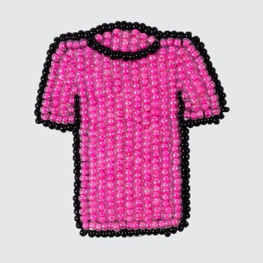 Beaded pin representing a pink shirt with a black outline.