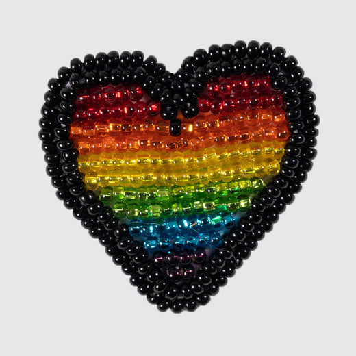 Beaded pin representing a heart filled with rainbow colours, with a black outline.