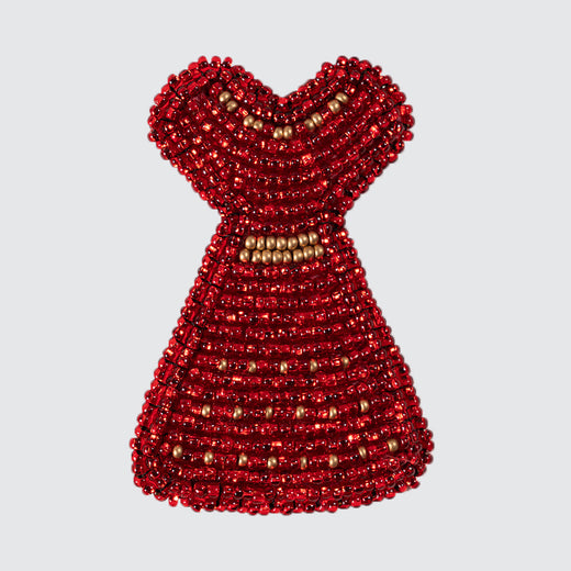 Beaded pin representing a red dress.