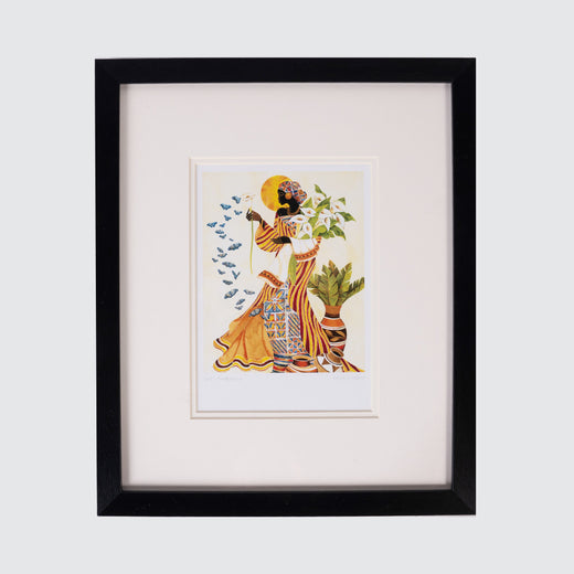 Art print in a black frame featuring a Black woman holding white flowers with blue butterflies fluttering next to her.
