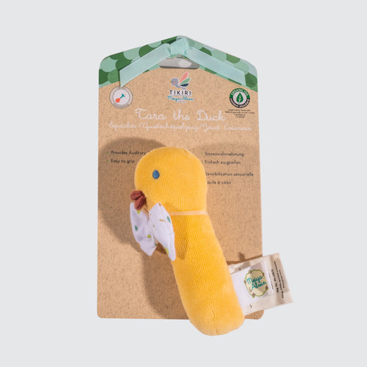 Vibrant yellow fabric toy duck wearing a white bow tie, attached to its packaging.